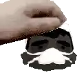 a hand is holding a man 's head with a mask on it .