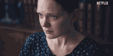 a close up of a woman 's face with netflix written on the bottom
