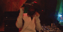 a person wearing a hat with a light on it is dancing