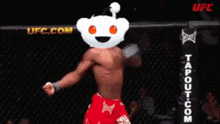 a man with a reddit face on his head stands in a ufc ring