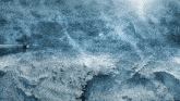 a blue background with a few clouds and a boat in the distance