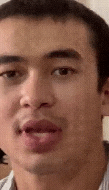 a man is making a funny face with his mouth open .
