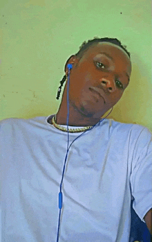 a man wearing a white shirt and blue earbuds