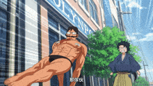 a man in a bathing suit stands in front of an olympus building