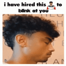 a picture of a man with curly hair and a caption that says " i have hired this to blink at you "