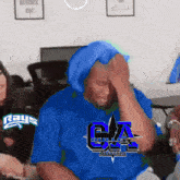 a man wearing a blue shirt that says bullets all stars