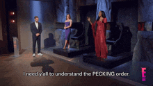 a man and two women on a stage with the words i need y'all to understand the pecking order on the bottom