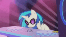 a cartoon pony wearing glasses and a horn is sitting on a table ..