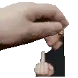 a hand is giving a middle finger to a man 's face .