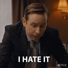 a man in a suit and tie says " i hate it " in a netflix ad
