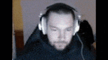 a man wearing headphones looks at the camera