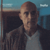 a bald man in a brown jacket is featured in a hulu ad