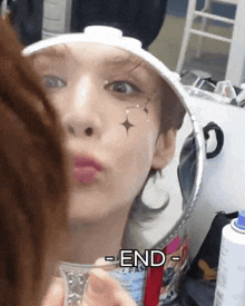 a woman is looking at herself in a mirror with the word end written on the bottom