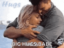a man and a woman hugging each other with the words `` big hugs babe '' .
