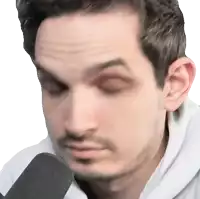 a close up of a man 's face with a microphone in the foreground