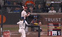 a baseball game is being played in front of a sign that says truist