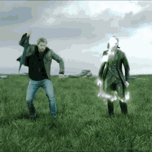 two men are dancing in a grassy field with the words fancykraken.tumblr in the bottom right corner