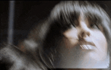 a blurry picture of a woman 's face with long hair