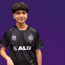 a boy wearing a black shirt with aldi written on it