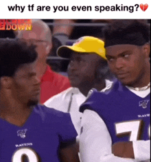 two ravens players are talking to each other in a crowd