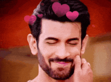 a man with a beard is smiling with hearts around his head