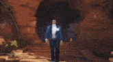 a group of men in blue tuxedos and white shirts are walking in a line