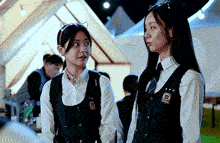 two girls are standing next to each other and one has a cat ear headband