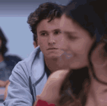 a group of people are sitting in a classroom .