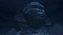 a statue of a man 's face is surrounded by a green light
