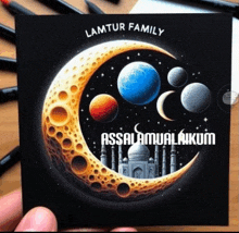 a drawing of a crescent moon with the words " lamtur family " on it