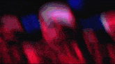 a blurry picture of a red and black background with a few spots of light on it .