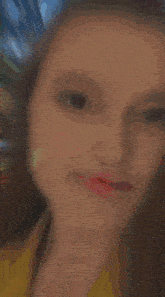 a blurry picture of a girl holding a red object