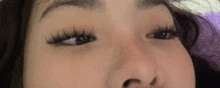 a close up of a woman 's eye with long eyelashes