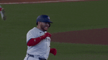 two blue jays players are hugging each other on the field