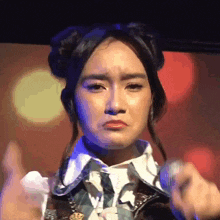 a close up of a woman making a face with her hands