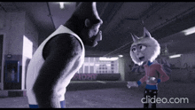 a gorilla and a lynx are standing next to each other with clideo.com in the background