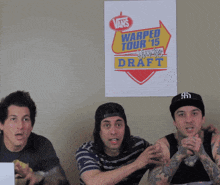 three men sitting in front of a poster that says vans warped tour 2015 draft
