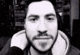 a black and white photo of a man with a beard and mustache