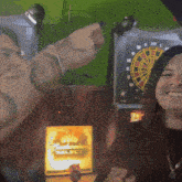 a man and a woman are standing in front of a dart board