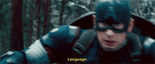 a close up of a man in a superhero costume with the words `` language '' written on the bottom .