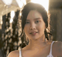 a close up of a woman 's face with the sun shining on her face