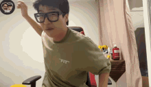 a man wearing glasses and a shirt that says " fit " on it