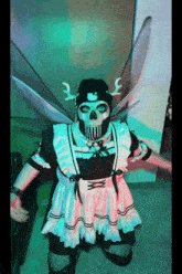 a person dressed in a maid costume with a skull mask on