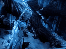 a woman in a white dress is standing next to a tree in a dark room