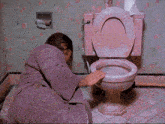 a man in a purple robe is vomiting in a pink toilet