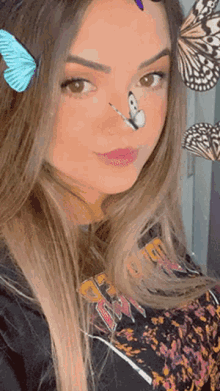 a woman with a butterfly on her nose is wearing a black shirt with the word guns n roses on it