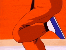 a close up of a person 's leg in front of an orange wall .