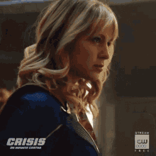 a woman in a superhero costume is looking at the camera .