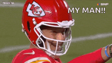 a close up of a football player wearing a helmet and smiling .