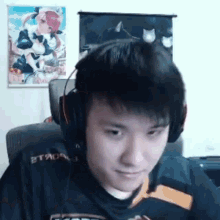 a man wearing headphones is sitting in a chair in front of a computer .